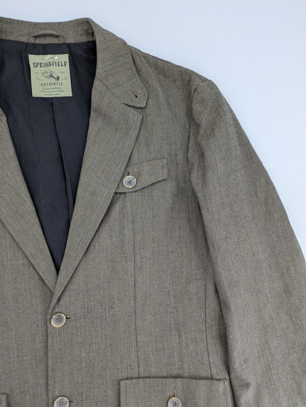 Springfield pink blazer with subtle pinstripe pattern and patch pockets.