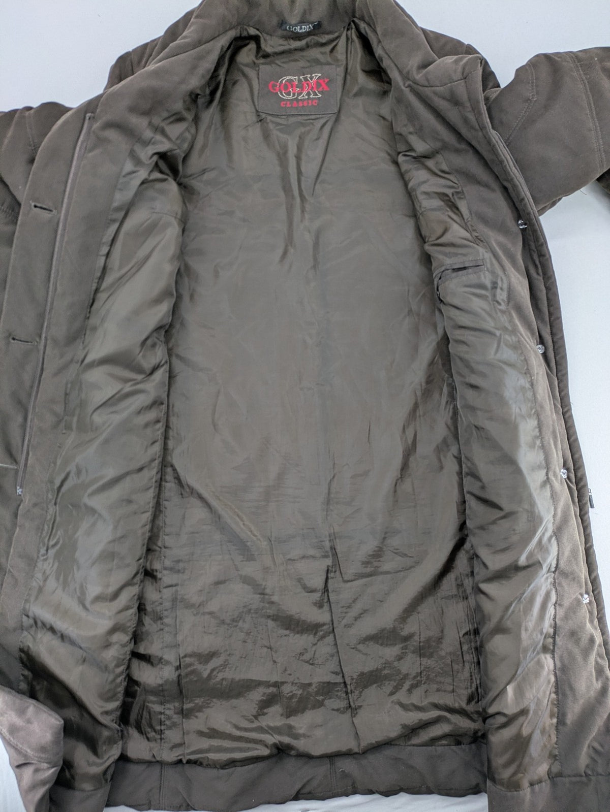 Goldix brown puffer coat size 46, button closure, padded design, classic style.