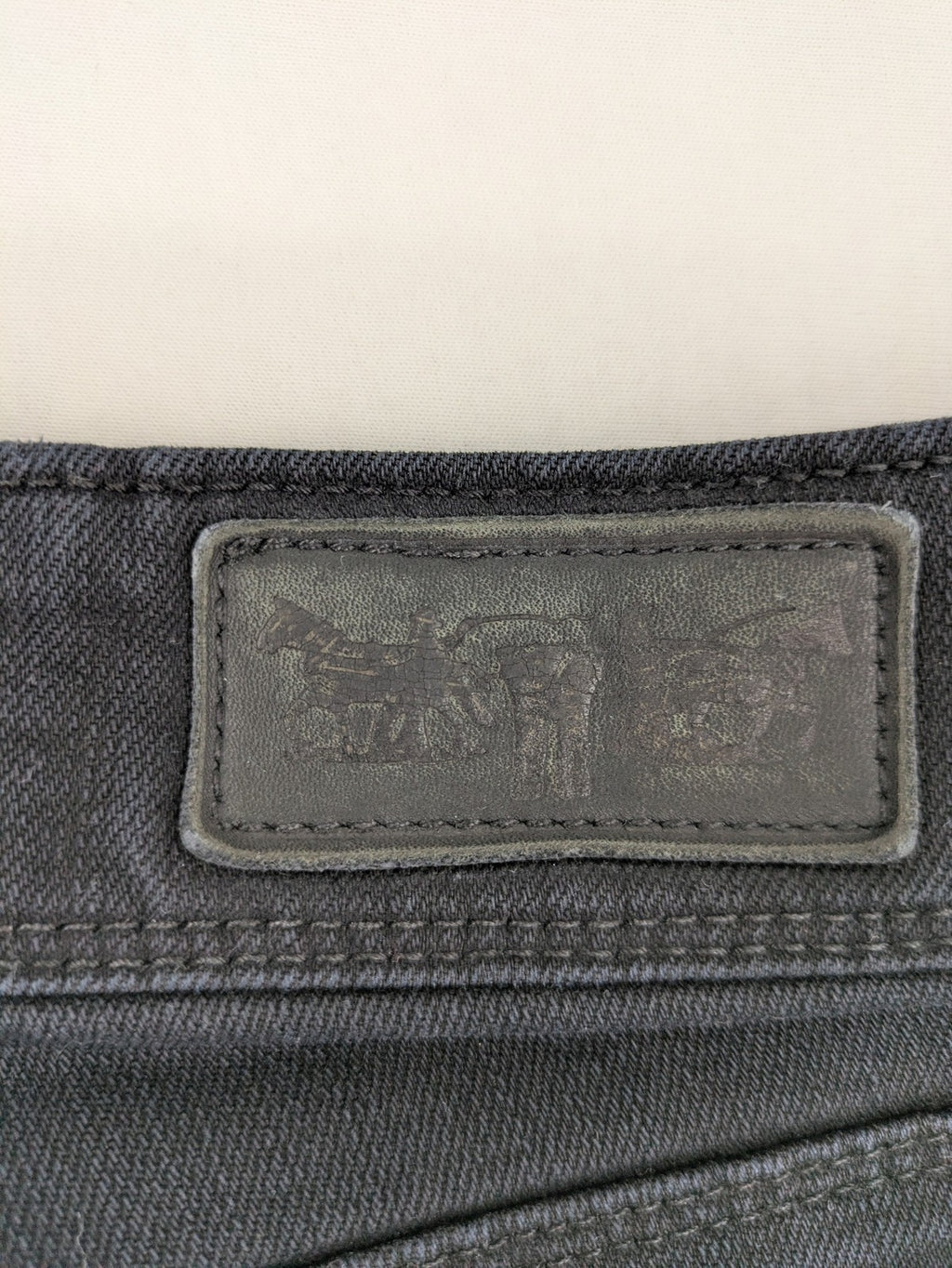 Levi's black slim fit jeans with classic 5-pocket design and zipper fly.
