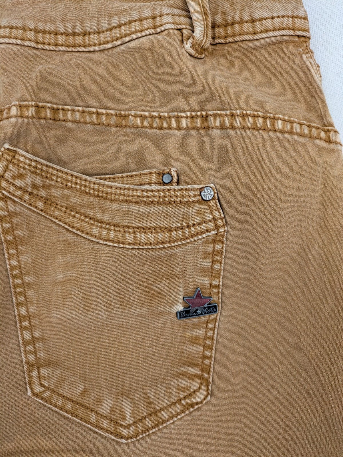 Buena Vista beige capri jeans with frayed hem and button fly detail.