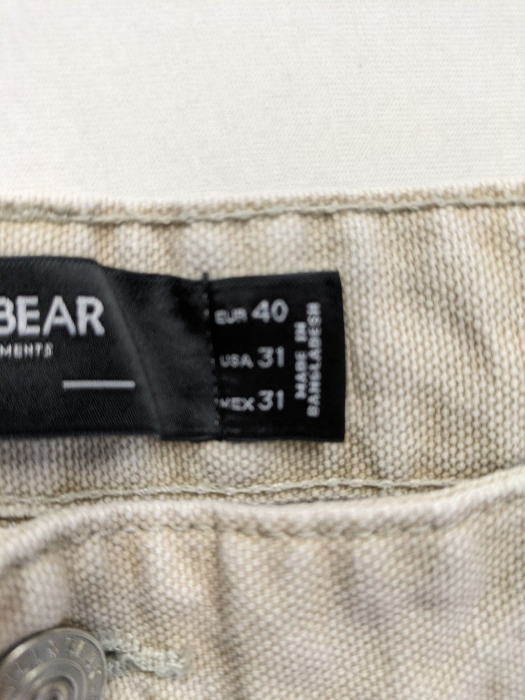 Pull&Bear beige carpenter pants with classic zipper, belt loops, and durable cotton material.