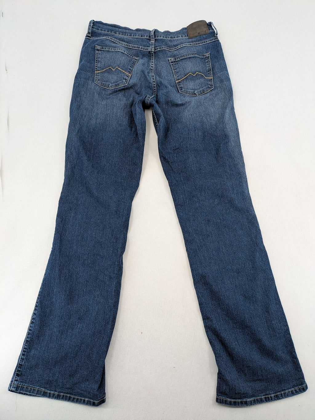 Mustang blue bootcut jeans with custom painted floral designs on both legs.