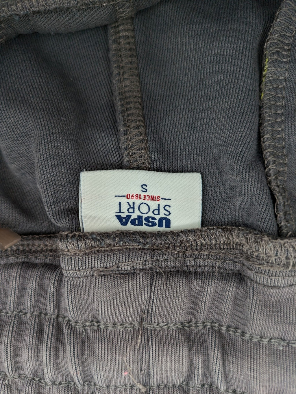 US Polo Assn grey sweatpants with light green drawstring and subtle logo detail.