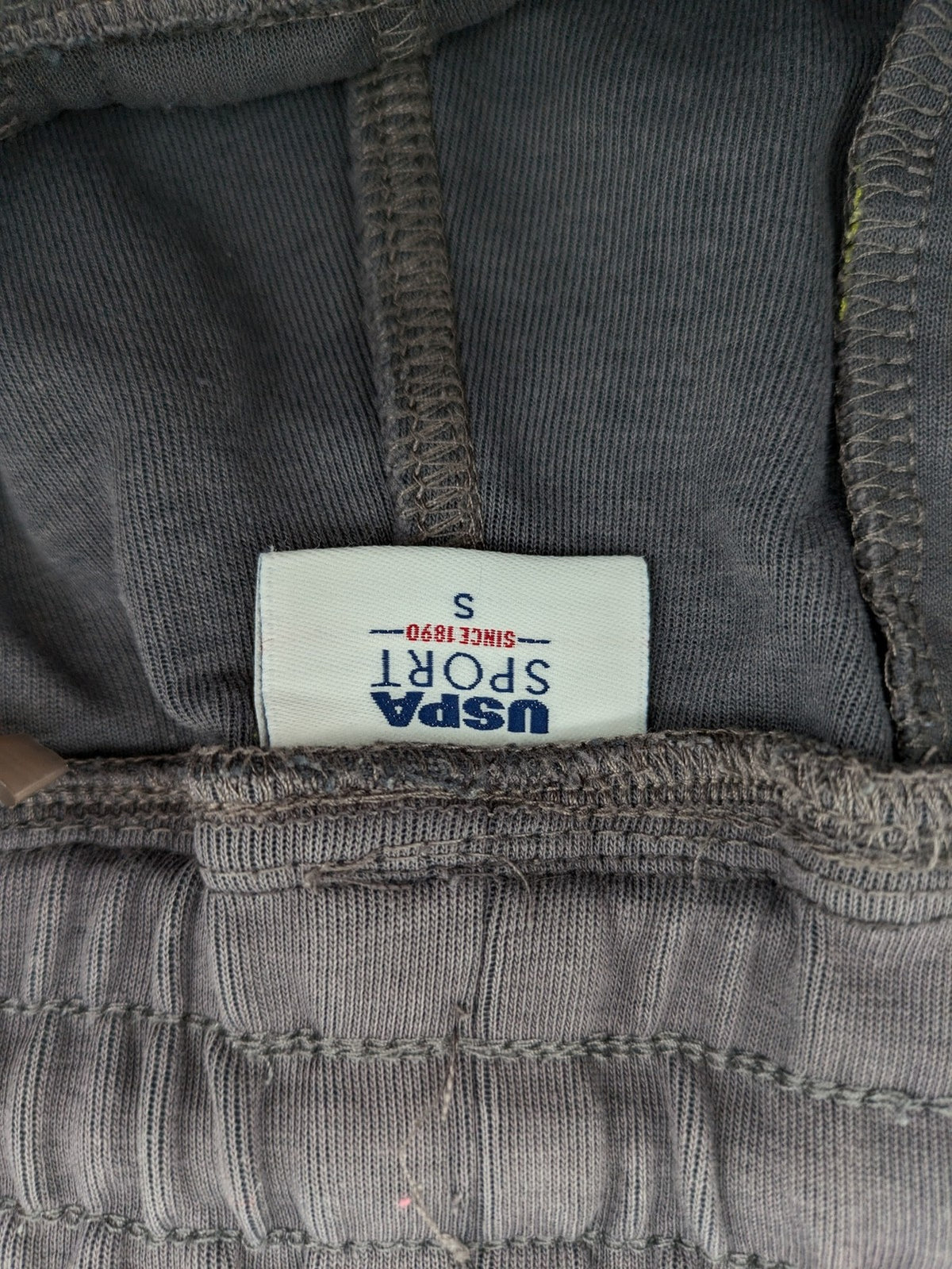 US Polo Assn grey sweatpants with light green drawstring and subtle logo detail.