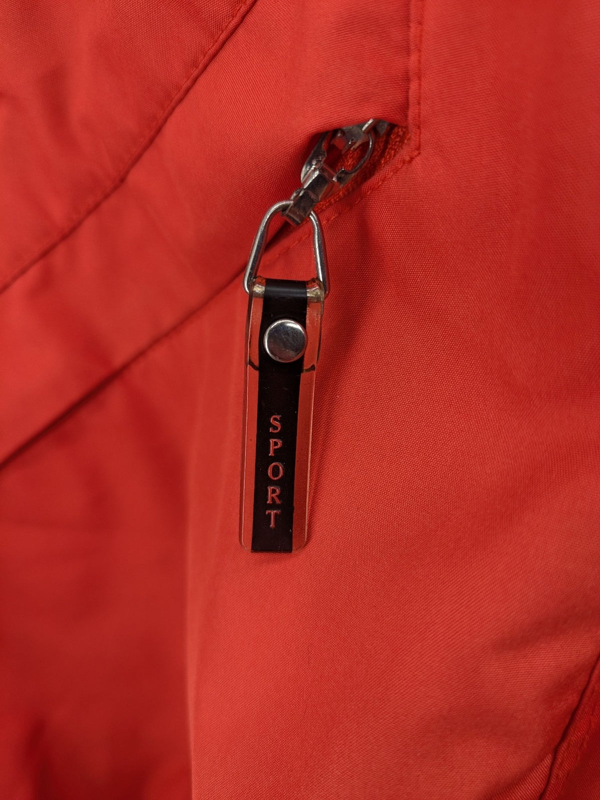 Sport Windbreaker orange jacket with adjustable hood, full zip, and button storm flap.