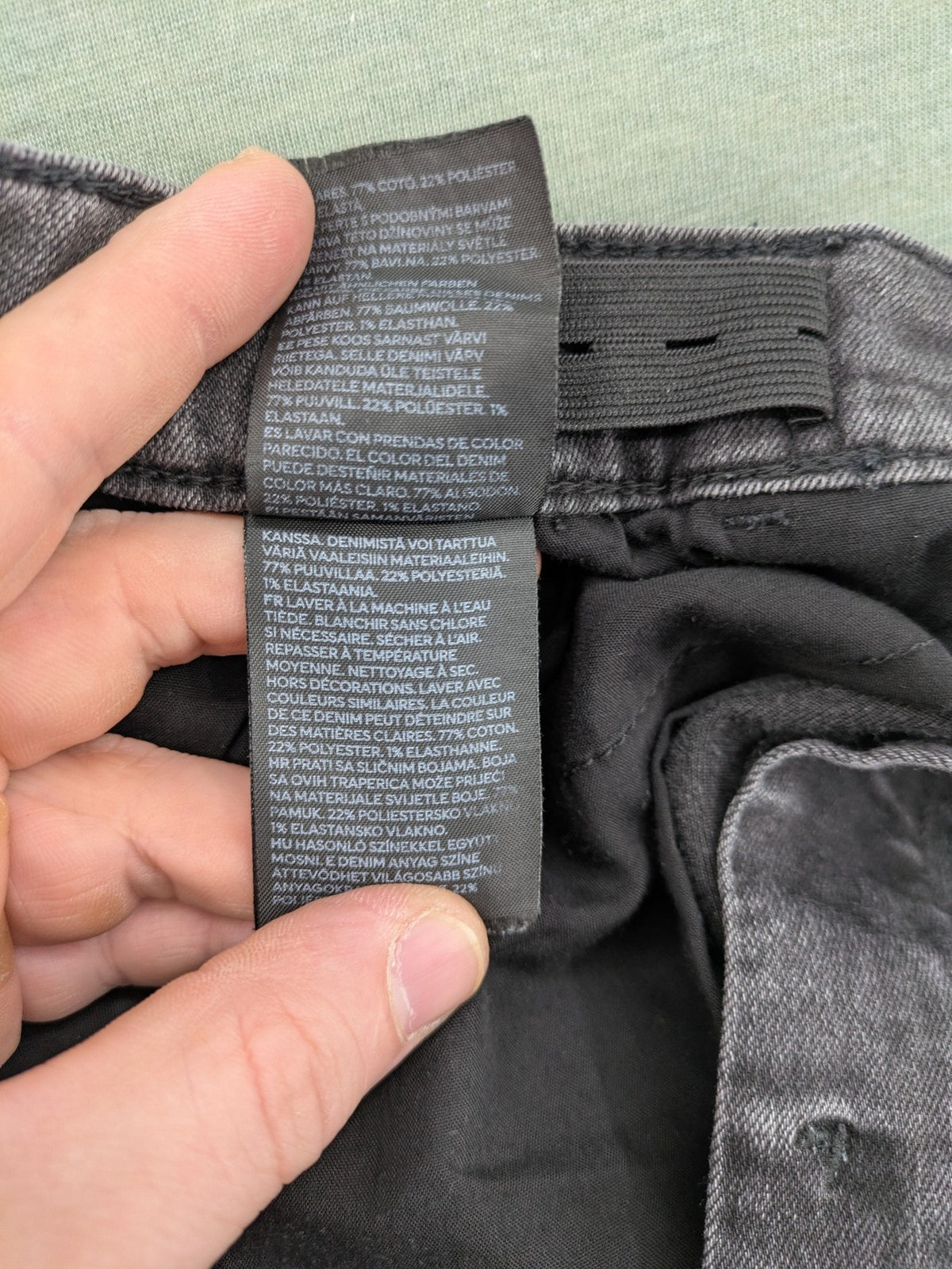 H&M grey slim fit jeans with adjustable waistband and faded wash detail.