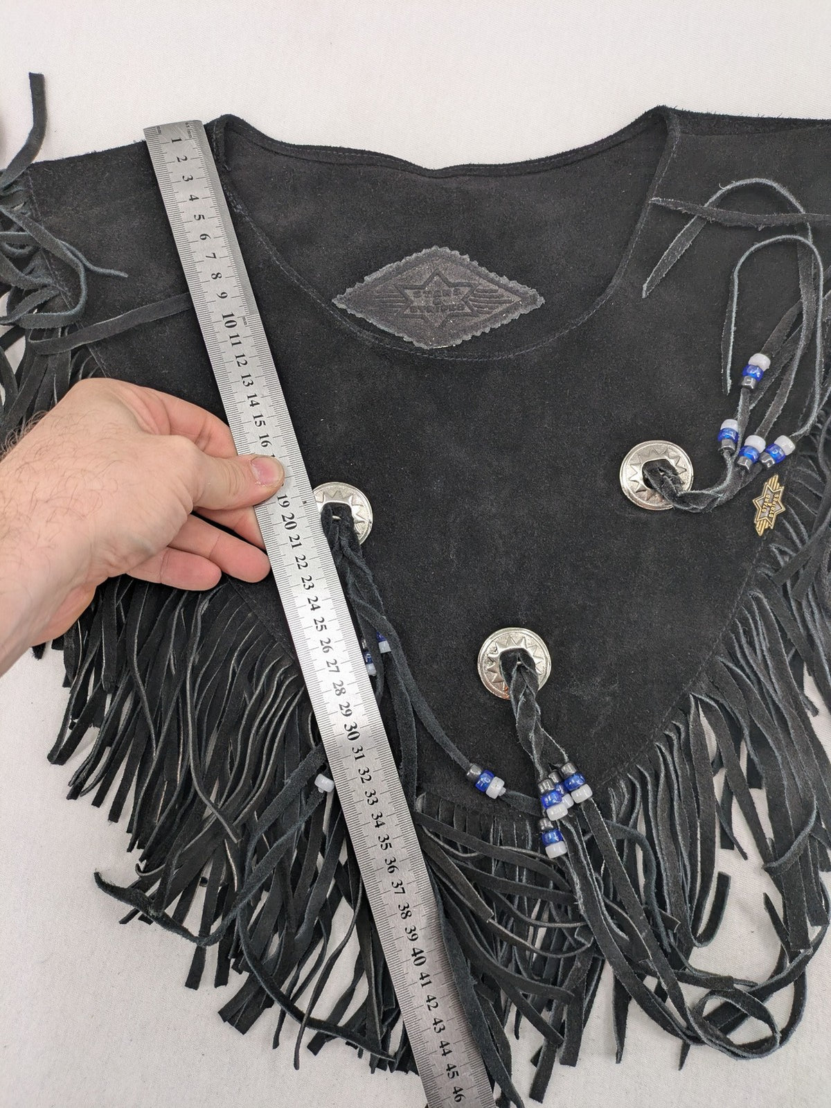 Stars & Stripes black suede fringe vest with silver conchos and beaded tassels.