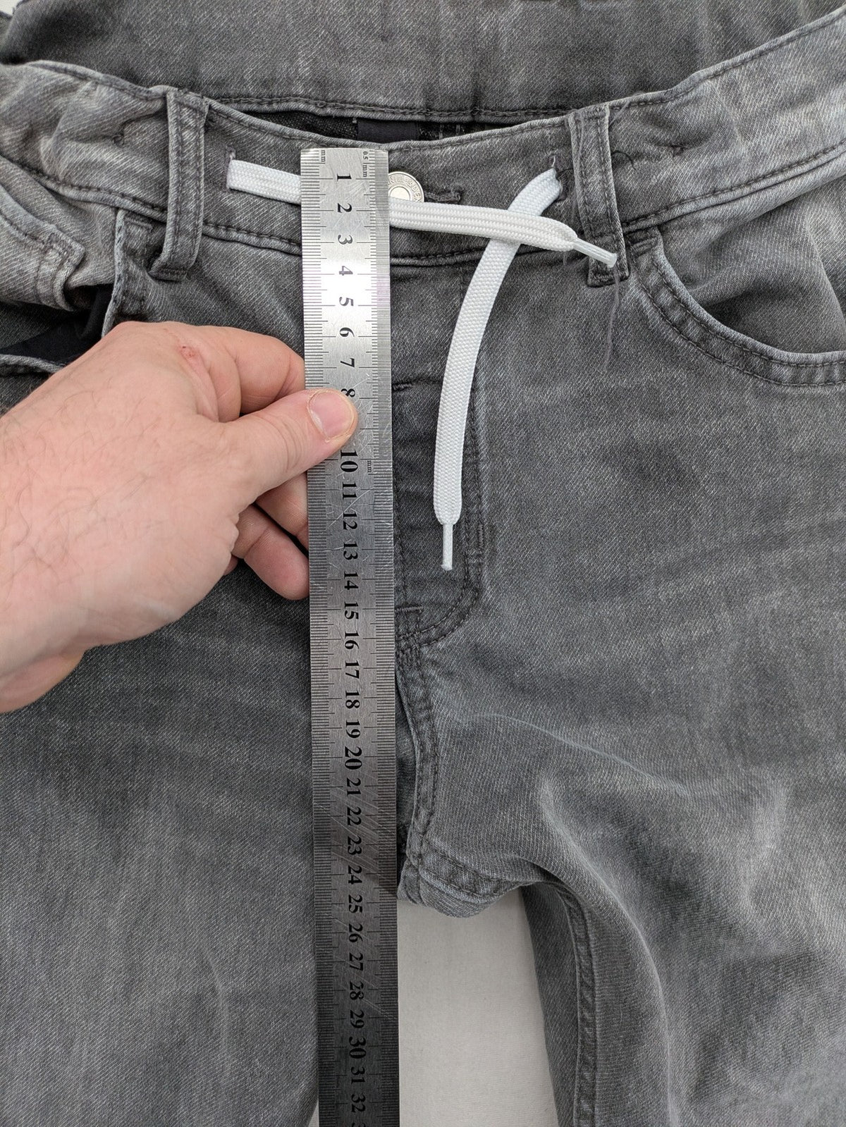 H&M grey jogger jeans with elastic waistband and drawstring, stylish washed look.