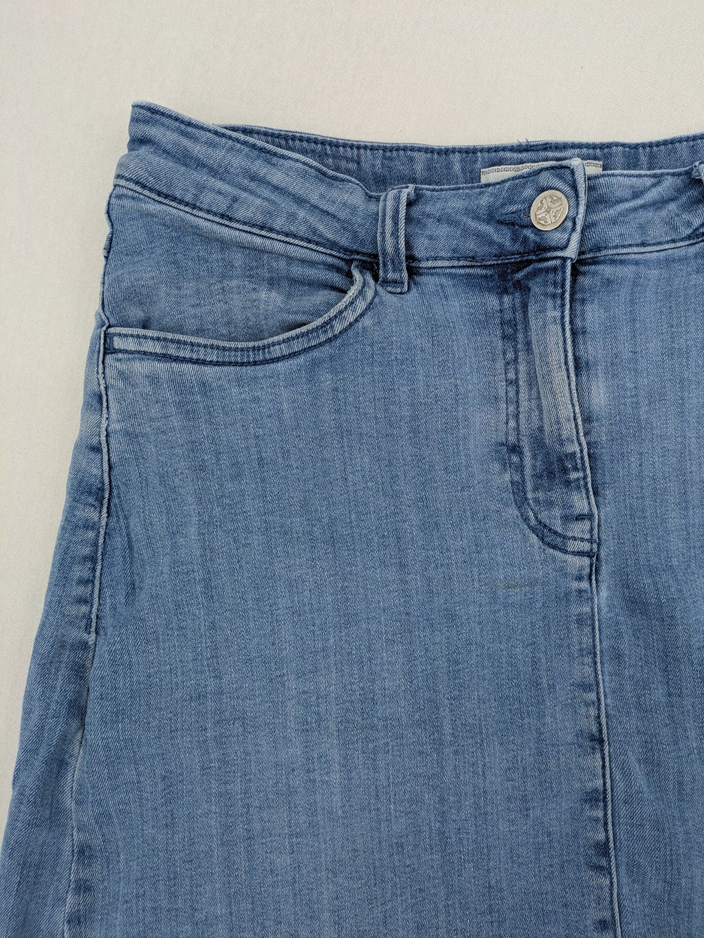 Tchibo blue A-line denim skirt classic five-pocket design with zipper and button closure.
