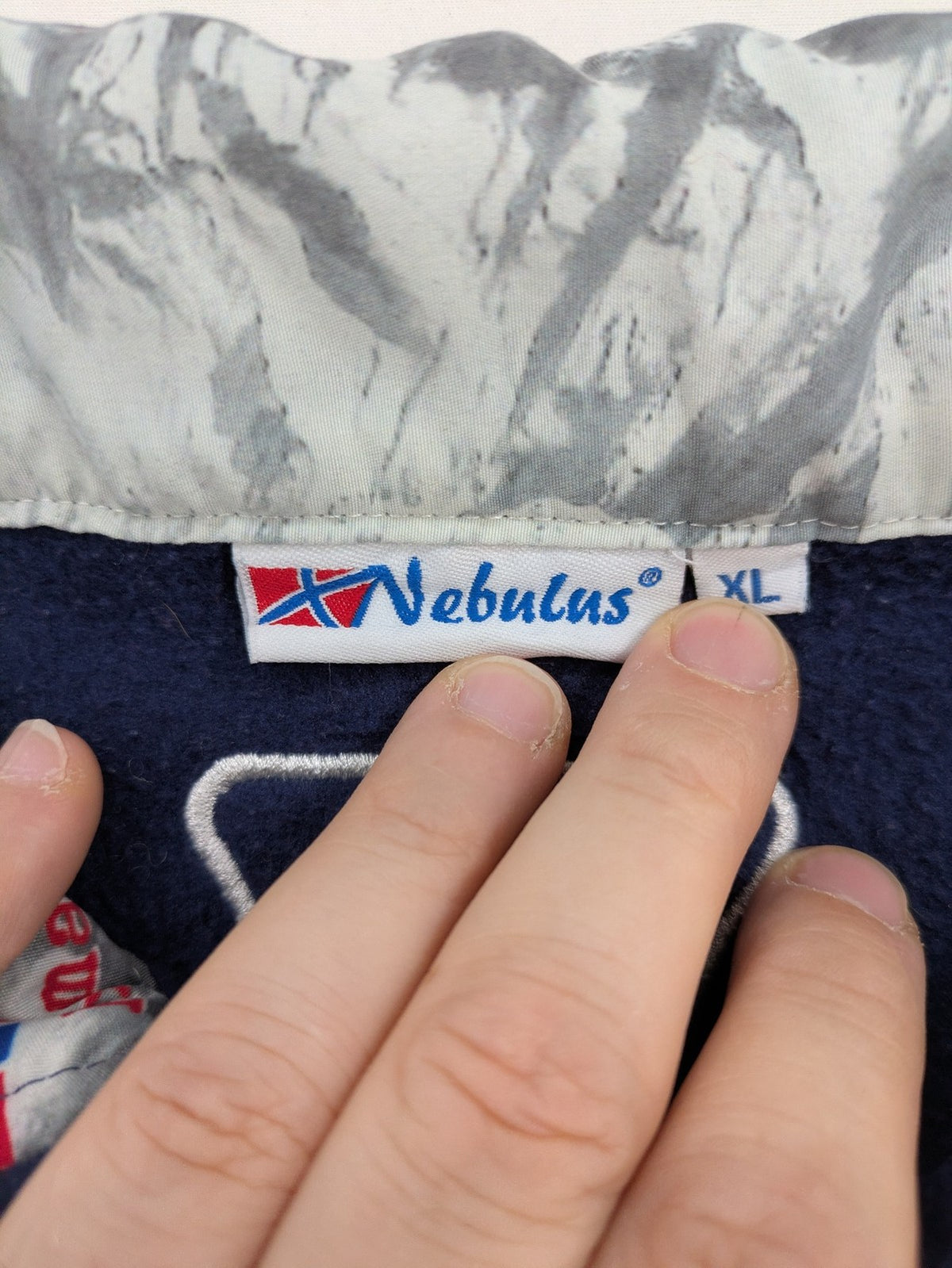 Nebulus navy turtle neck jumper with graphic print collar and "Himalaya Expedition" patch.