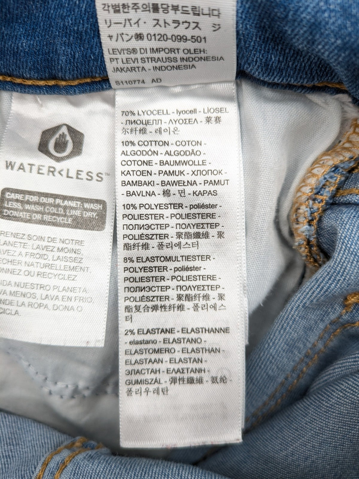 Levi's blue skinny jeans with raw hem, classic five-pocket design, and zip fly.