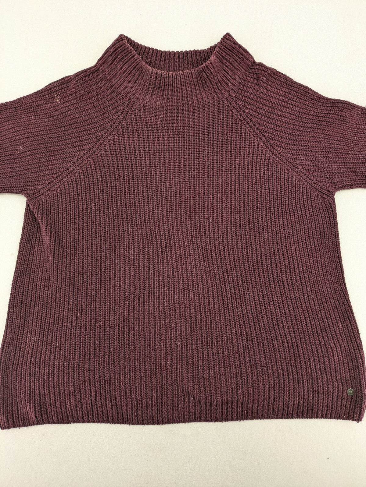 Monari burgundy knit jumper with standing collar, ribbed texture, and raglan sleeves.