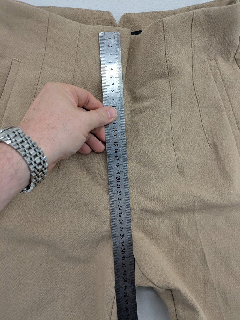 Tapered beige pants high-waist tapered fit with classic front creases and side pockets.