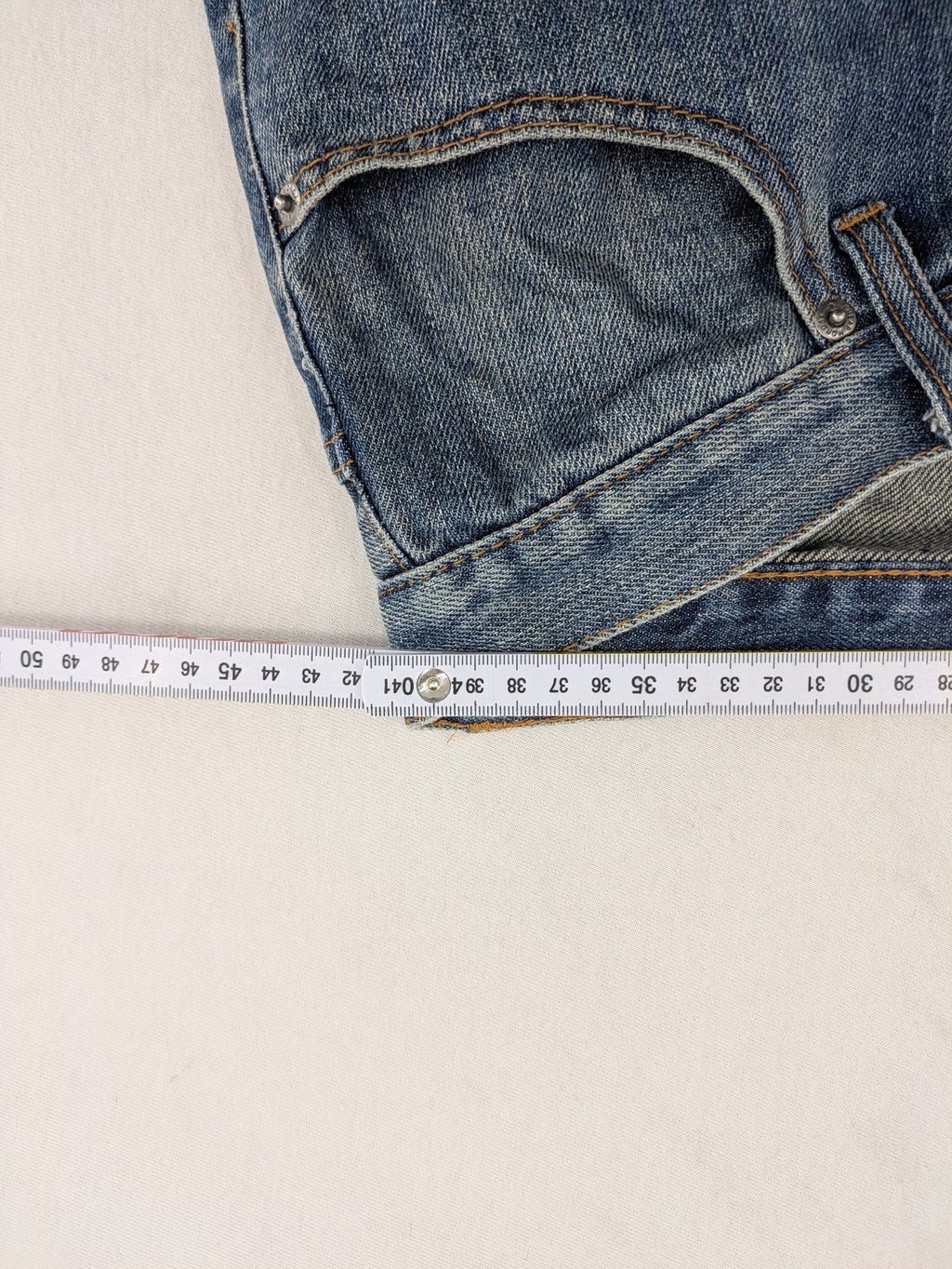Cheap Monday blue straight jeans with button fly and classic medium wash finish.