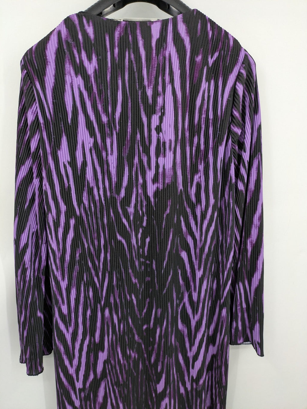 Untold black and purple pleated dress with animal print pattern and long sleeves.