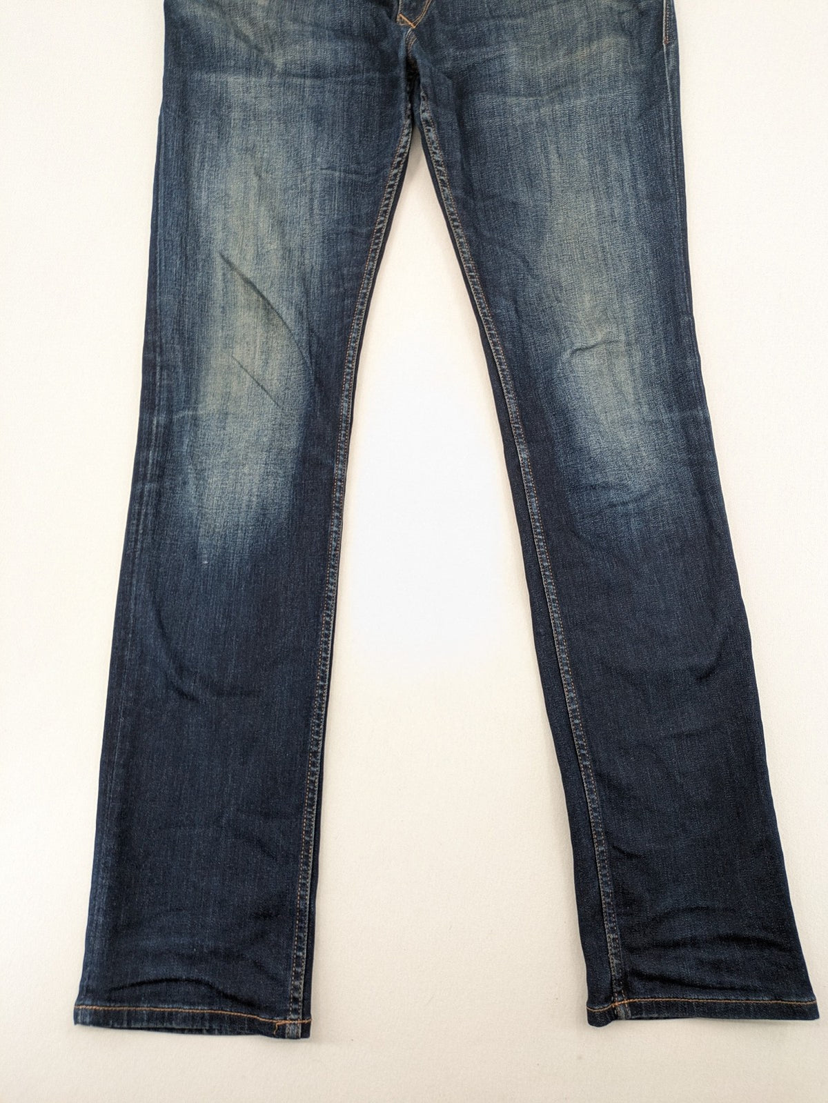 Tommy Hilfiger Denim blue straight jeans with five-pocket design and natural fading details.