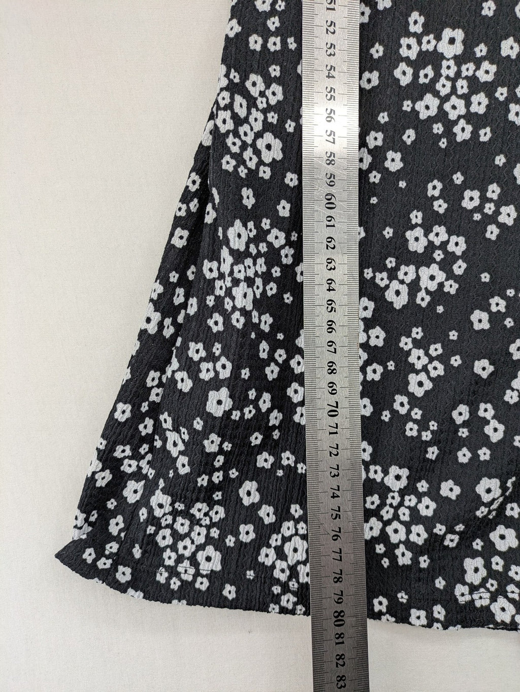 Clockhouse black and white floral mini dress with smocked bodice and puff sleeves.