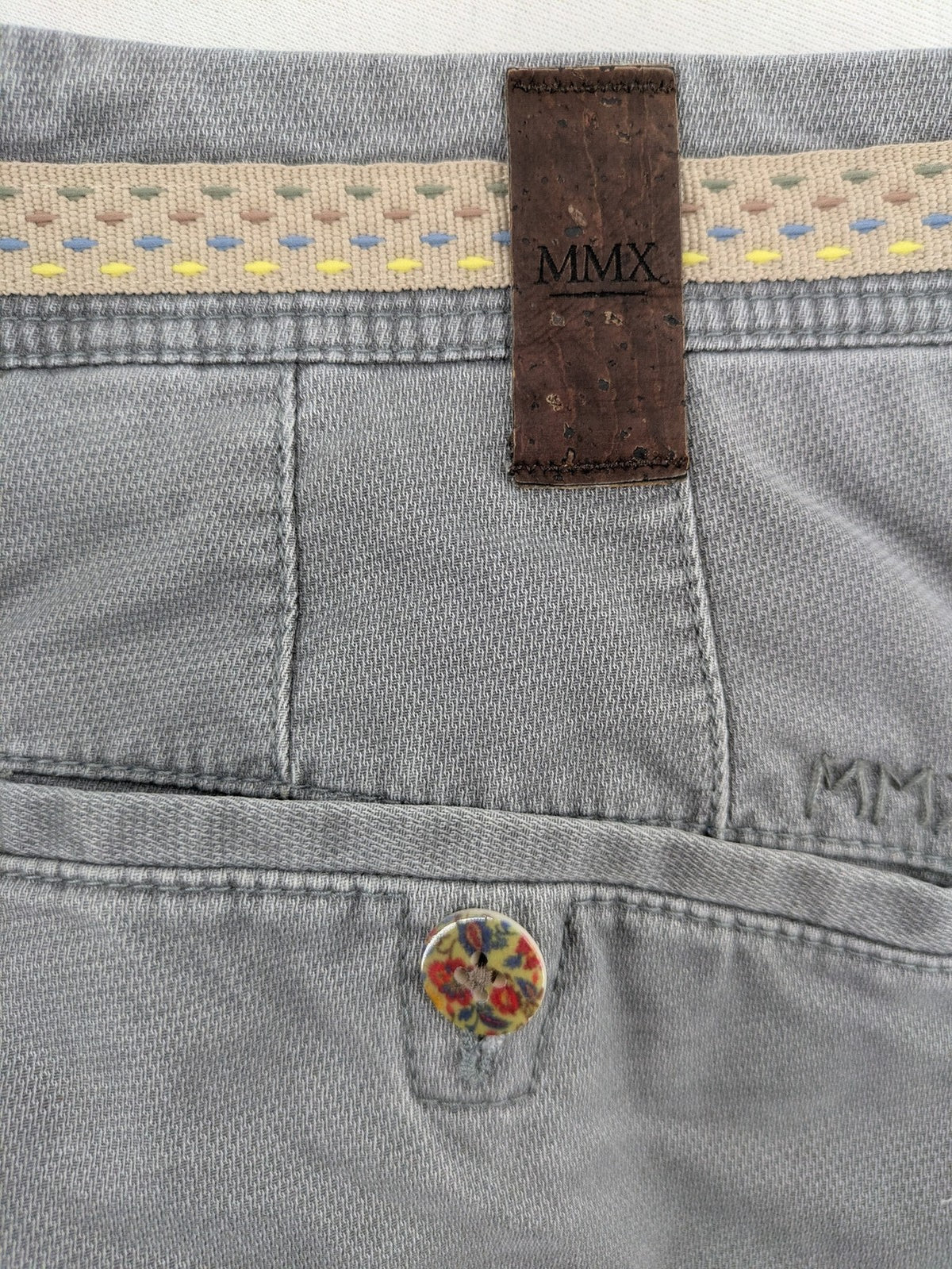 MMX grey chino pants with patterned interior lining and contrasting waistband, made from organic cotton.