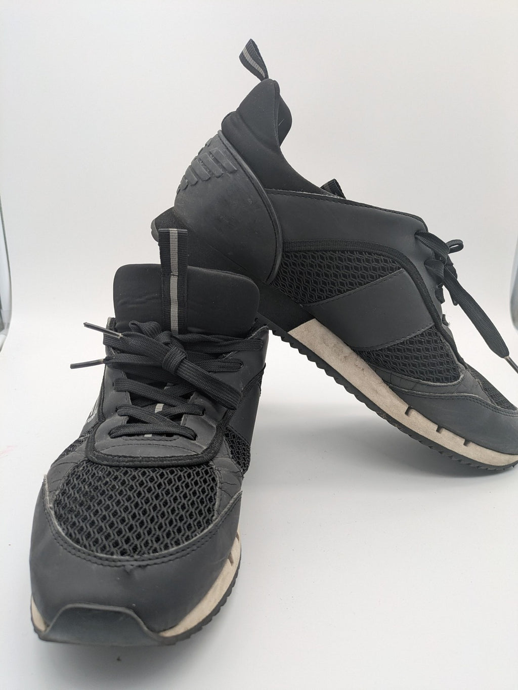 EA7 Emporio Armani beige and black sneakers with prominent EA7 branding and breathable mesh details.