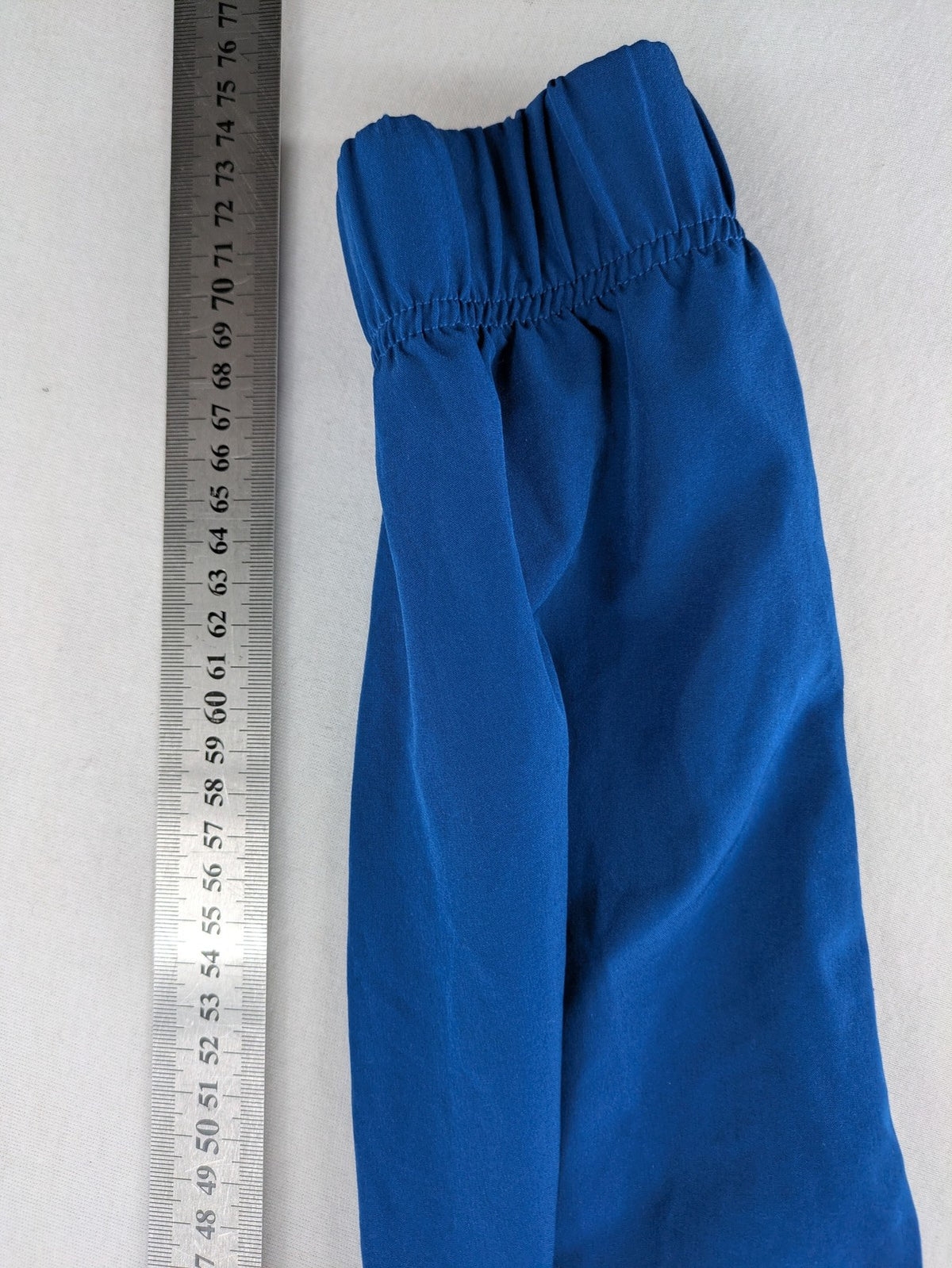 Under Armour blue HeatGear joggers with black accents and zippered cargo pockets.