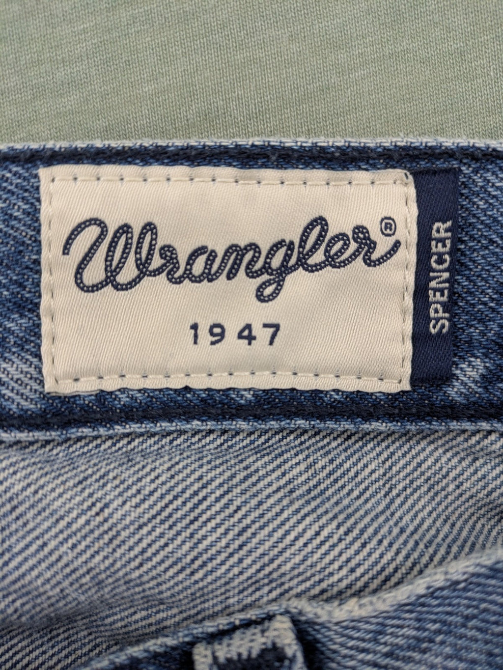 Wrangler blue straight jeans with button fly and classic 5-pocket design.