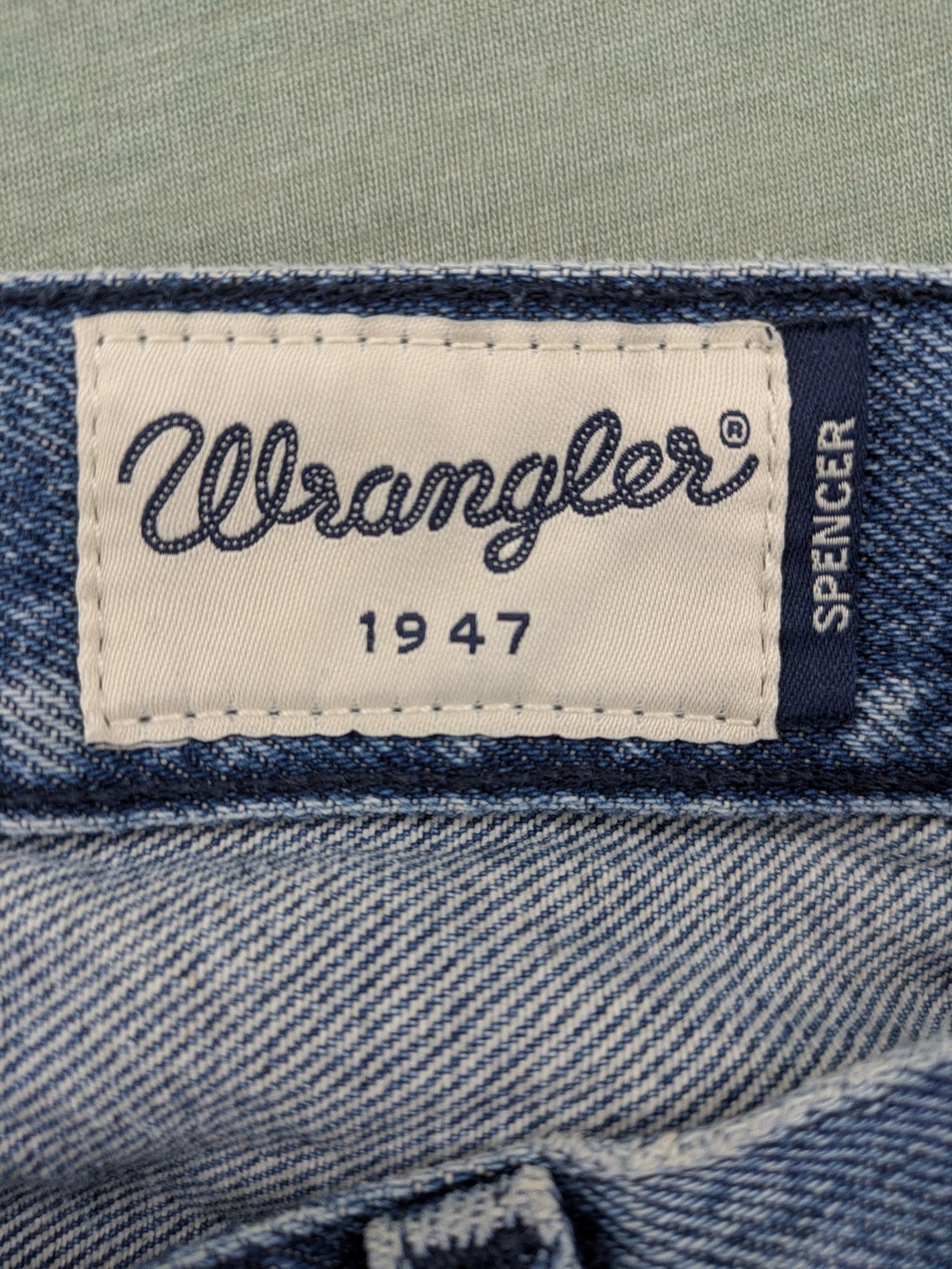 Wrangler blue straight jeans with button fly and classic 5-pocket design.