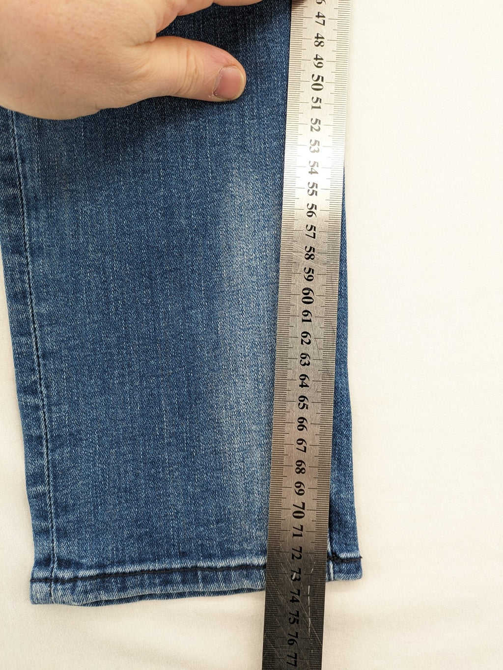 Crosshatch blue slim fit jeans with faded wash and logo patch on back pocket.