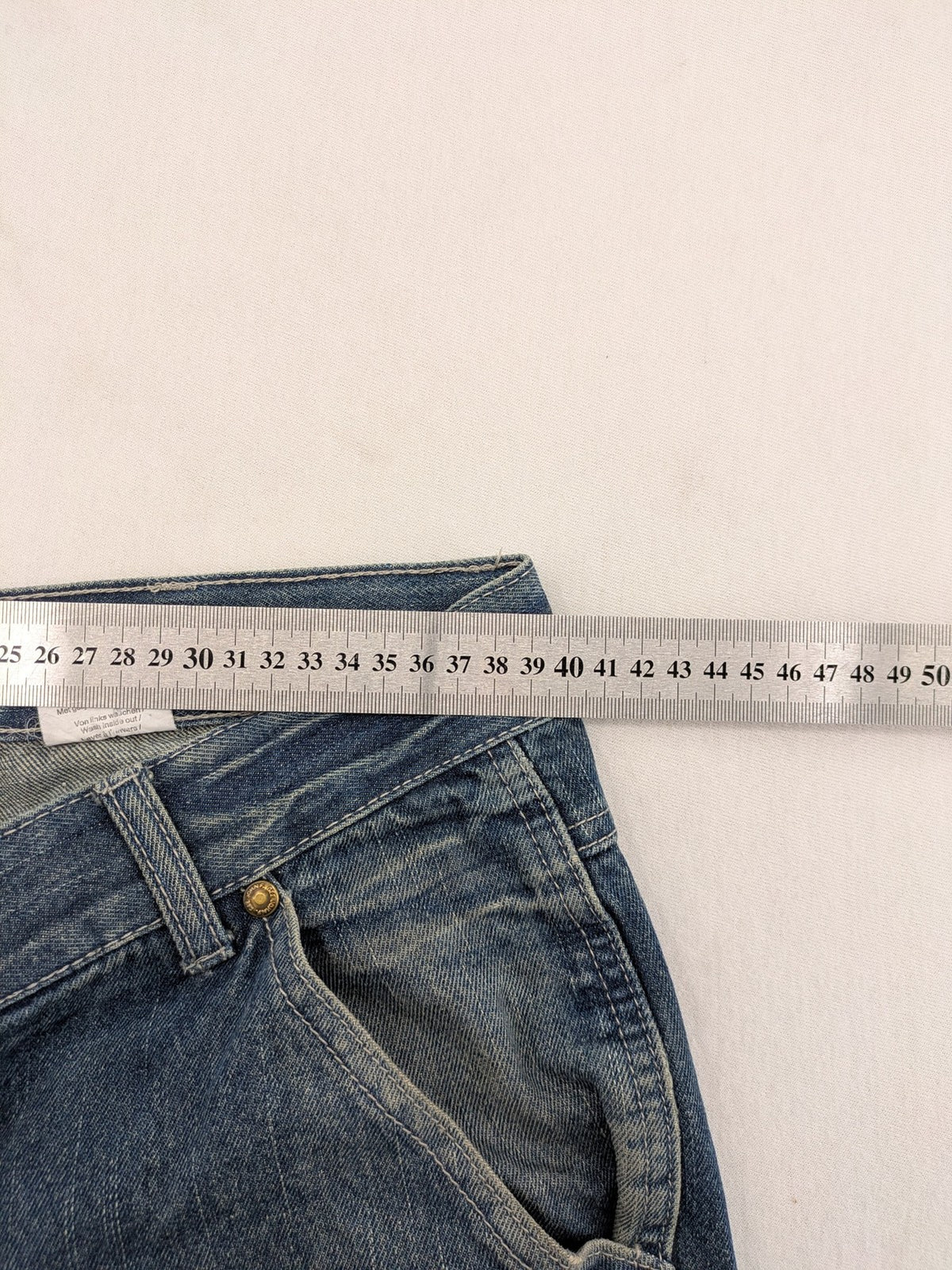 John F. Gee blue straight jeans with reinforced knees and durable denim material.
