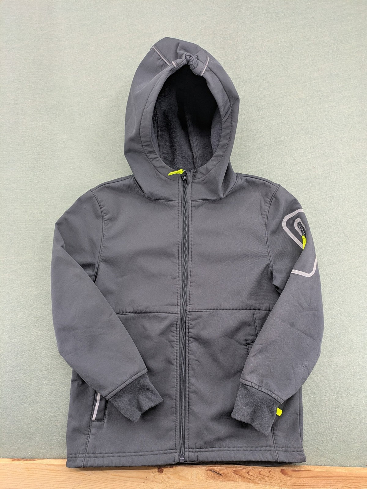 Yigga grey softshell coat with fleece lining, hood, and reflective details.