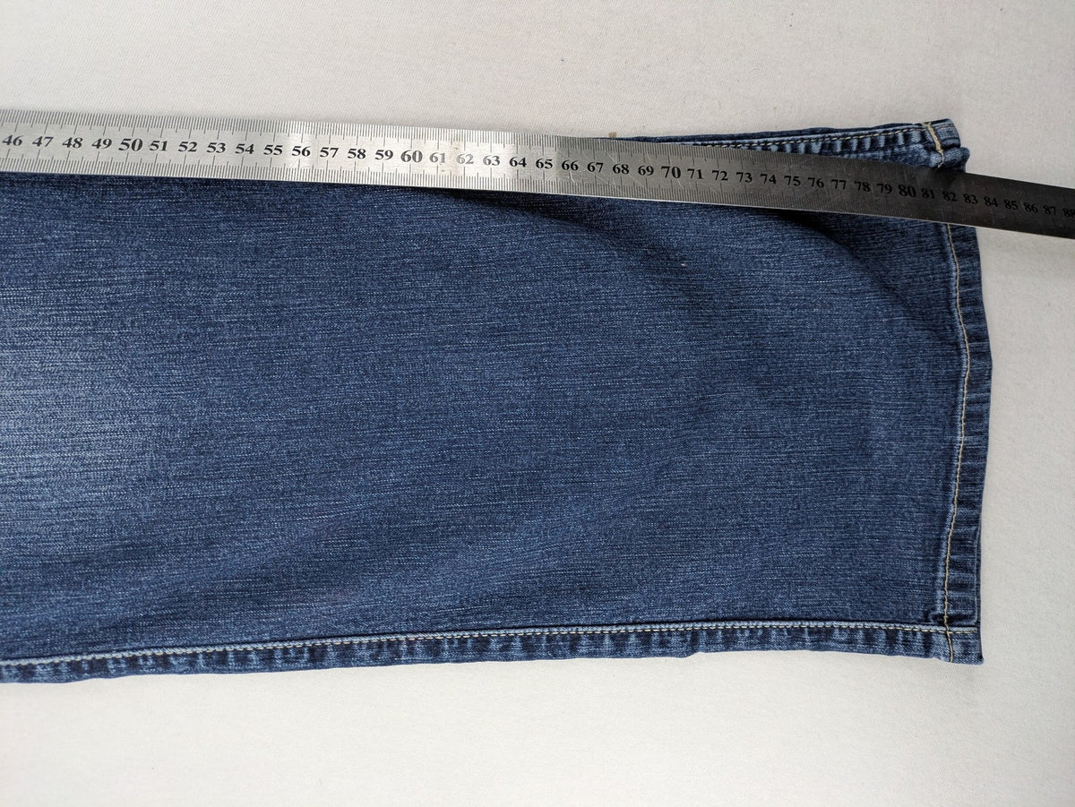 Mustang blue bootcut jeans with custom painted floral designs on both legs.