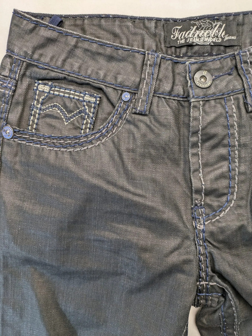 Fadnoble grey straight jeans with button fly and contrasting stitching details.