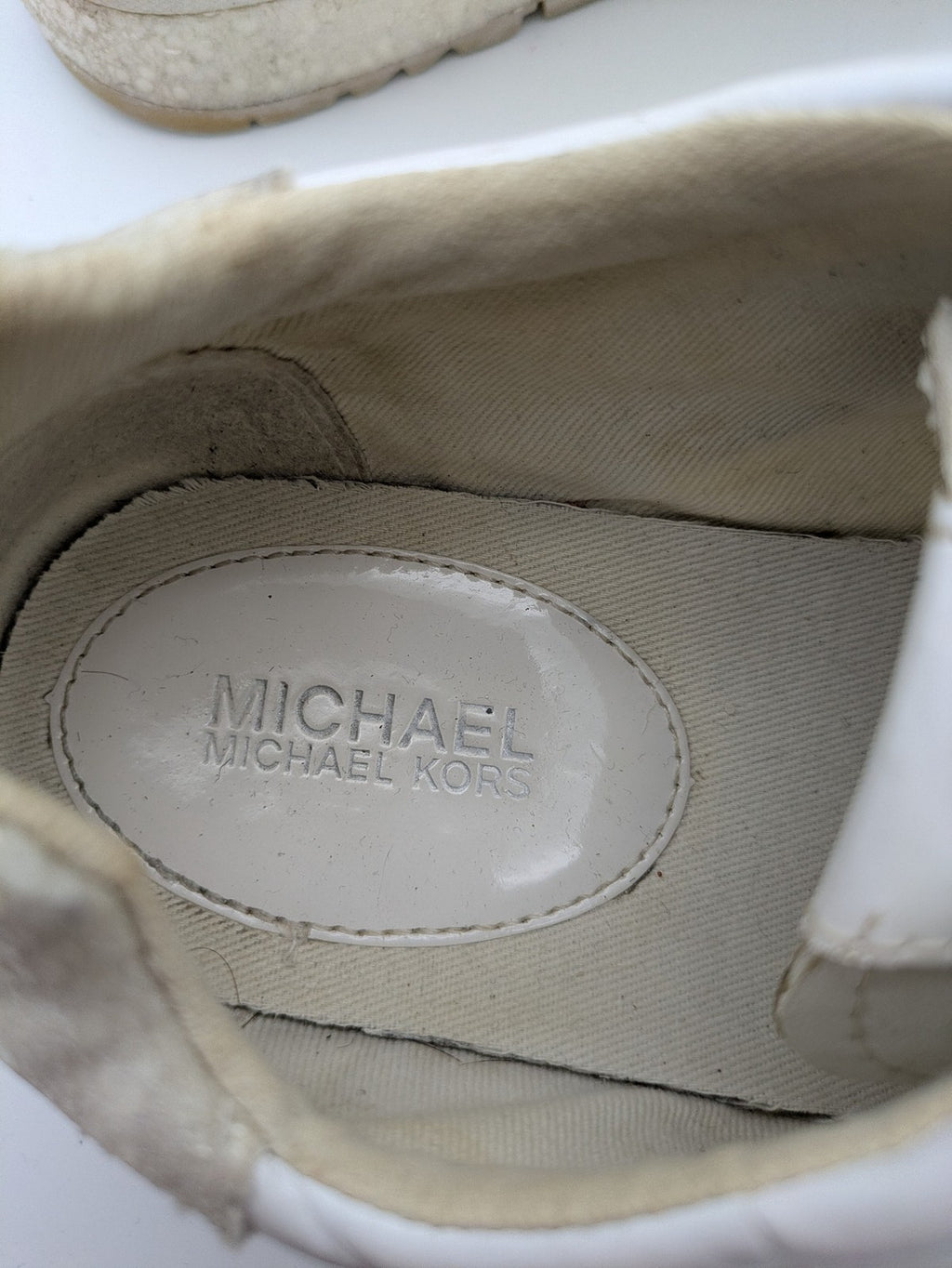 Michael Kors multi sneaker white leather and cream textile with silver logo details.