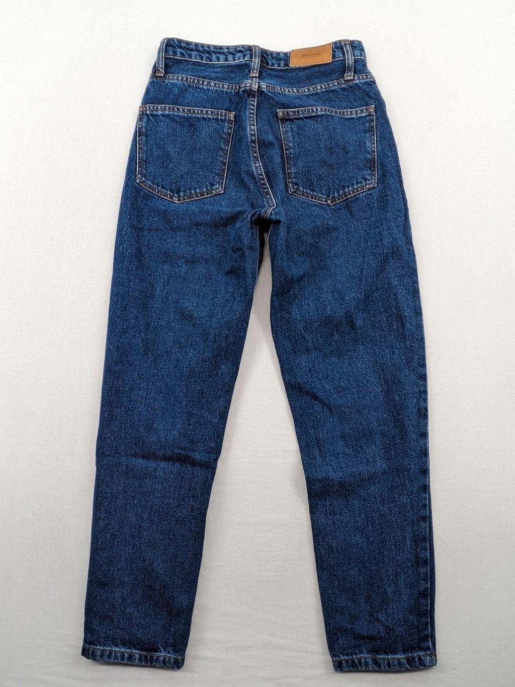 Stradivarius blue mom jeans high waist with button fly and classic denim texture.