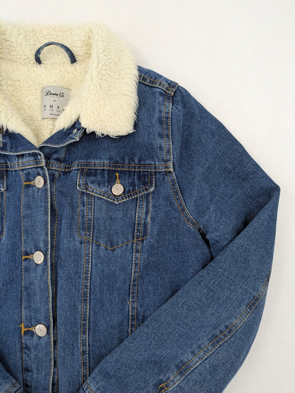 Denim & Co. blue jacket with cream Sherpa lining, button closure, and pockets.