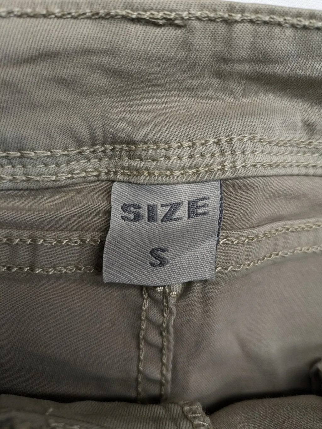 Mozaar beige straight jeans with unique asymmetrical button placket and practical pockets.