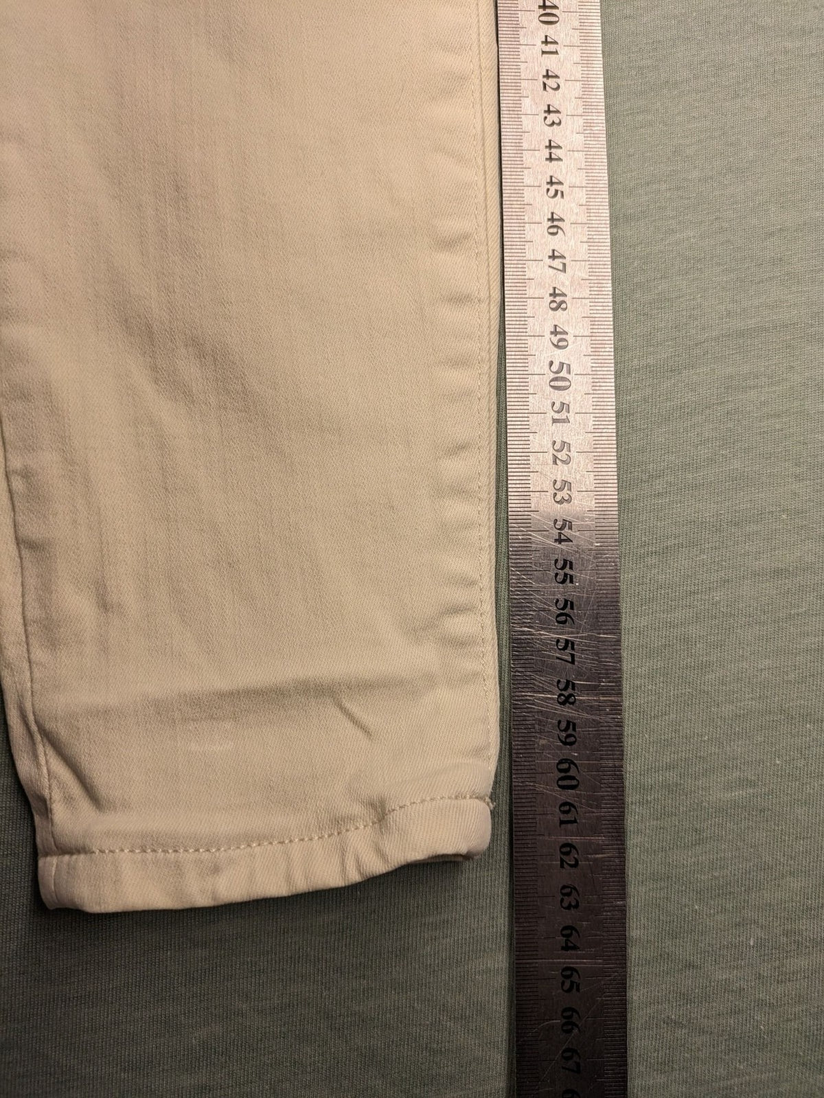 Tommy Jeans beige high rise skinny ankle jeans with logo patch and stretch fabric.
