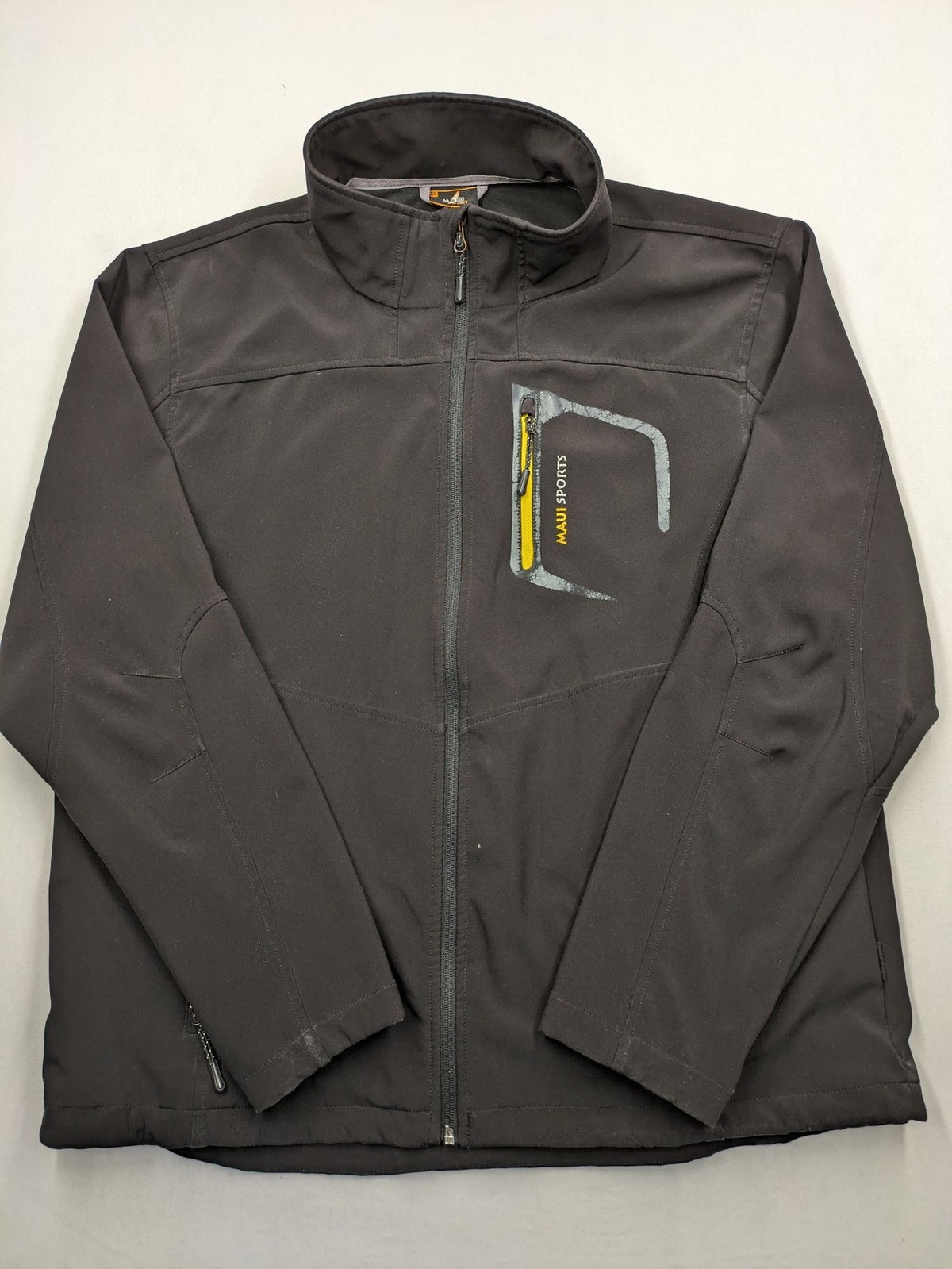 Maui Sports grey softshell jacket XL with contrasting yellow zipper and multiple pockets.