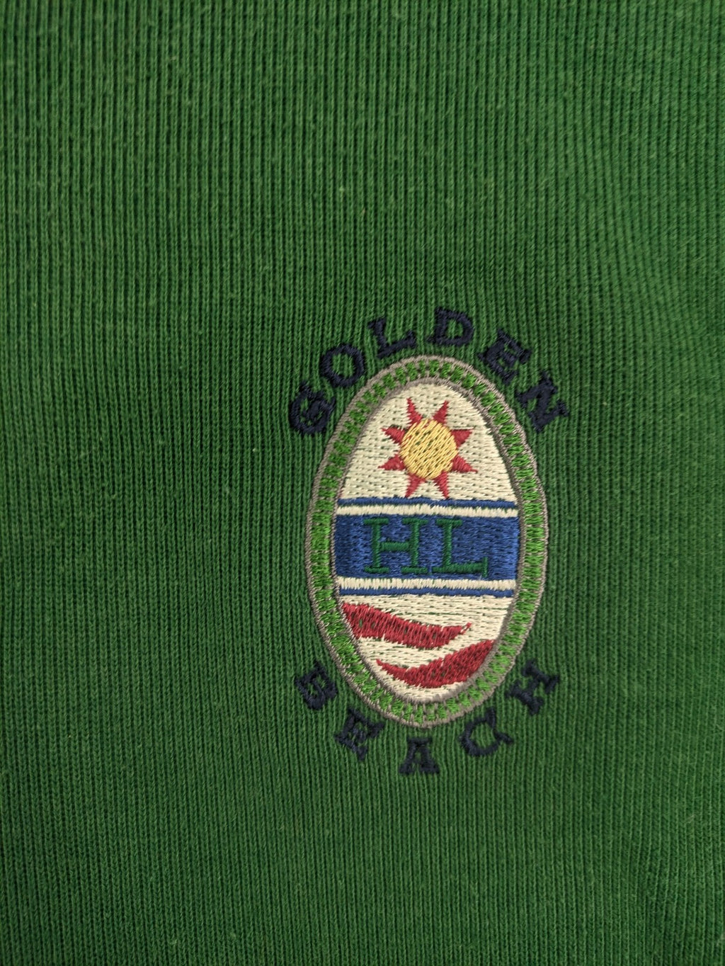 Headlands green turtle neck jumper with gingham collar and "Golden Beach" embroidery.