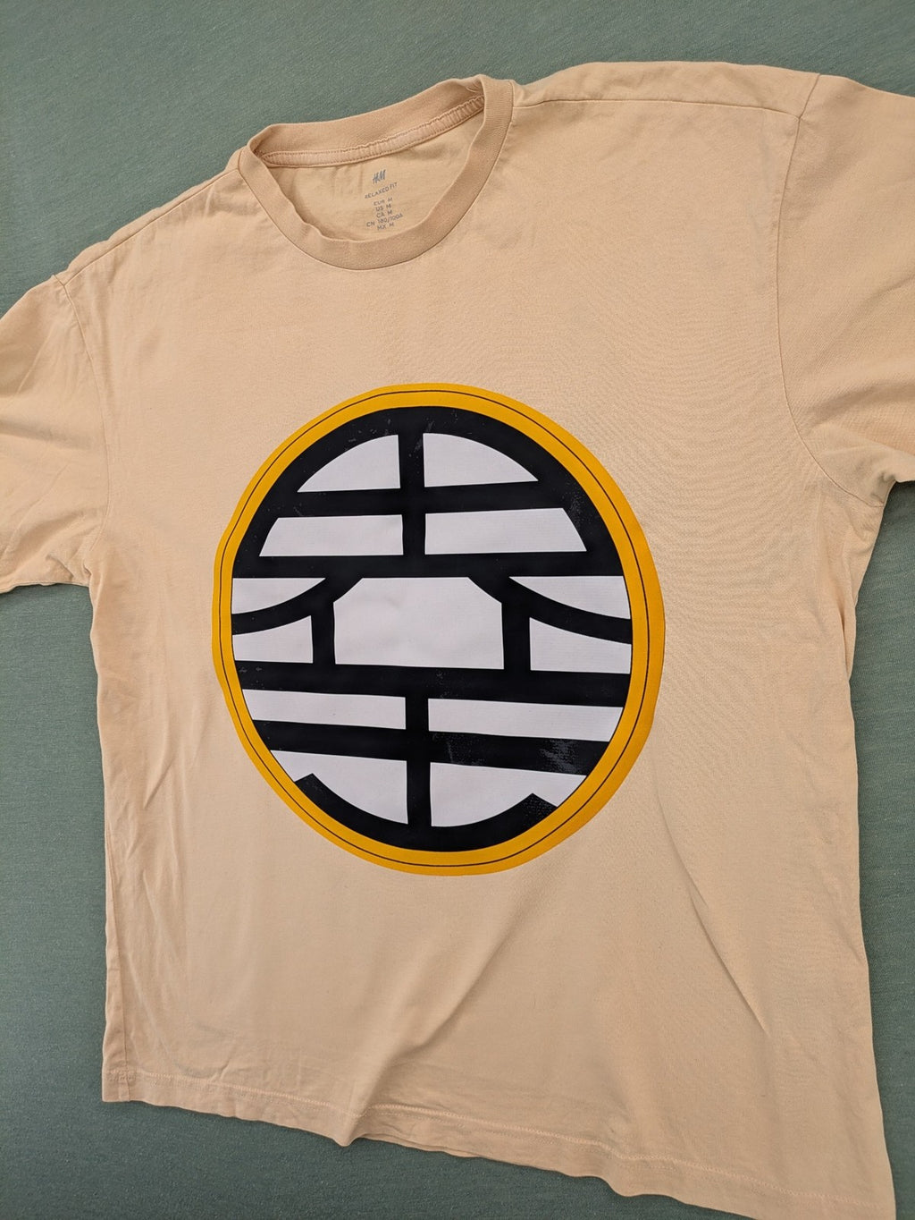 Dragon Ball Z beige t-shirt relaxed fit featuring Goku Go kanji symbol.