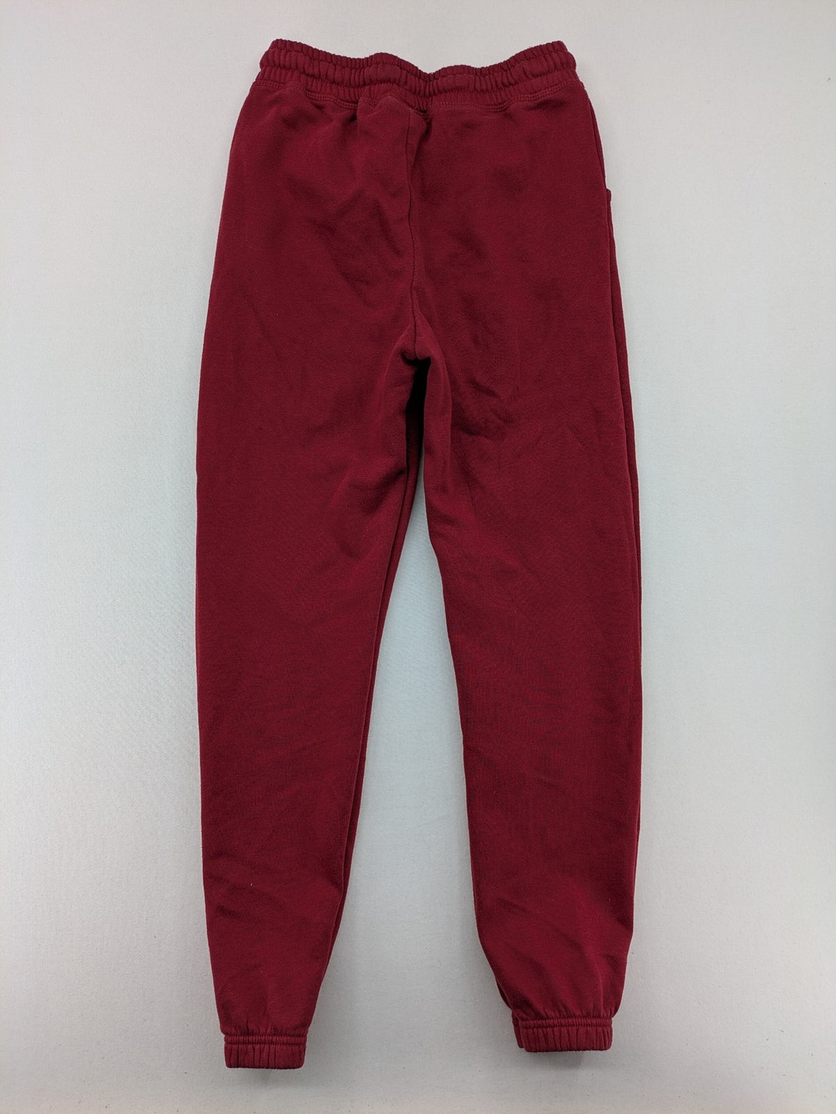 Harry Potter burgundy sweatpants featuring "HOGWARTS" print and Chibi graphic of Harry, Ron, Hermione.