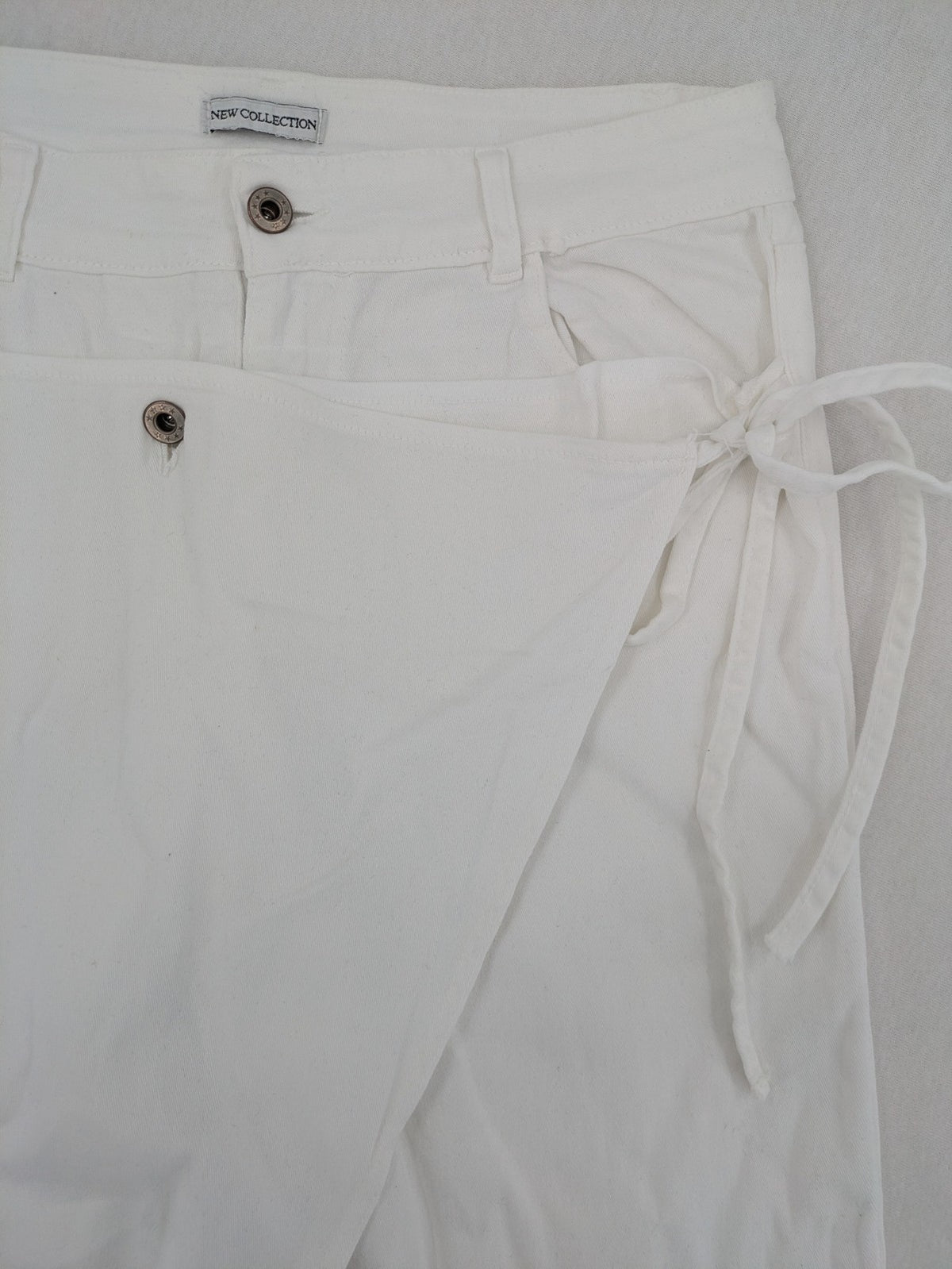 New Collection white straight jeans asymmetrical wrap design with side lacing and cotton-stretch material.