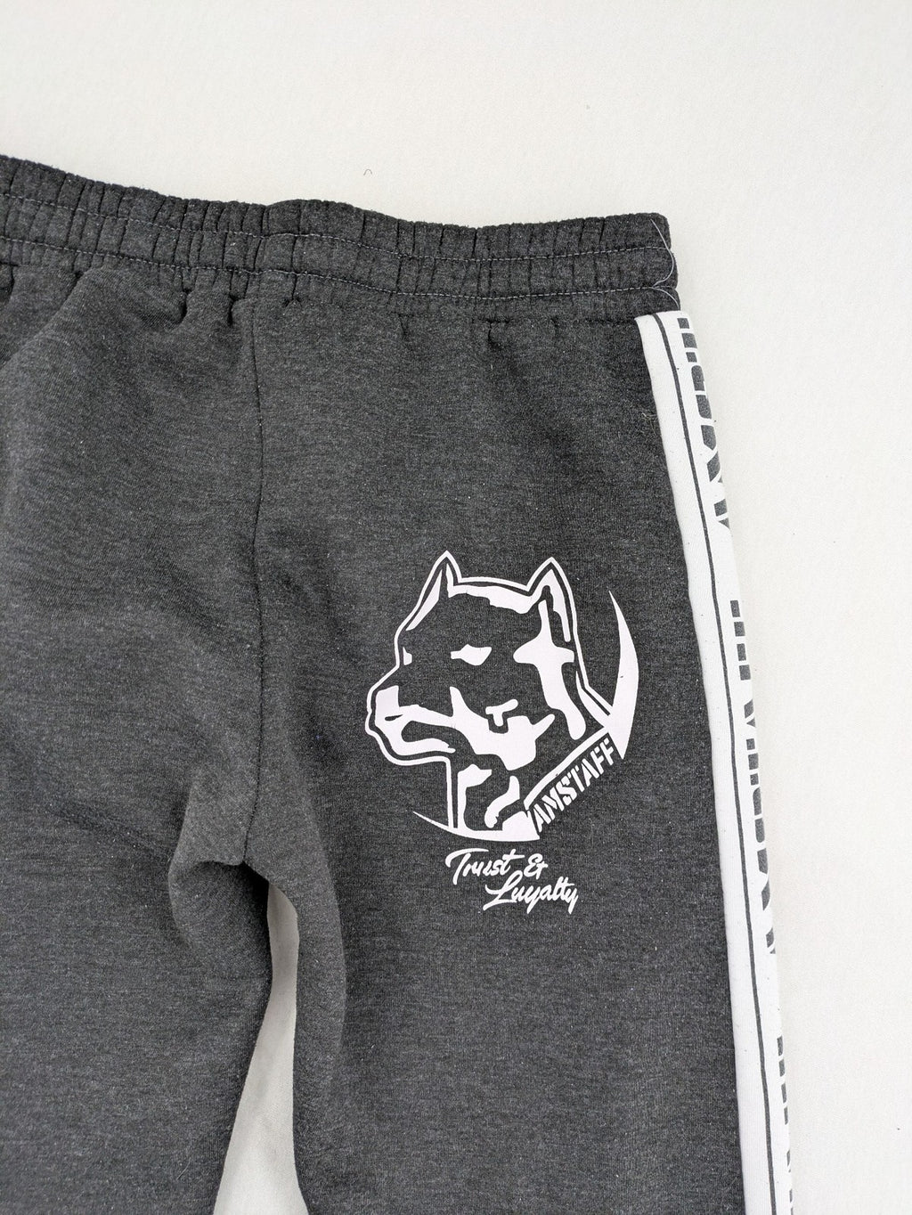 Amstaff grey sweatpants with large dog logo and "Trust & Loyalty" text.