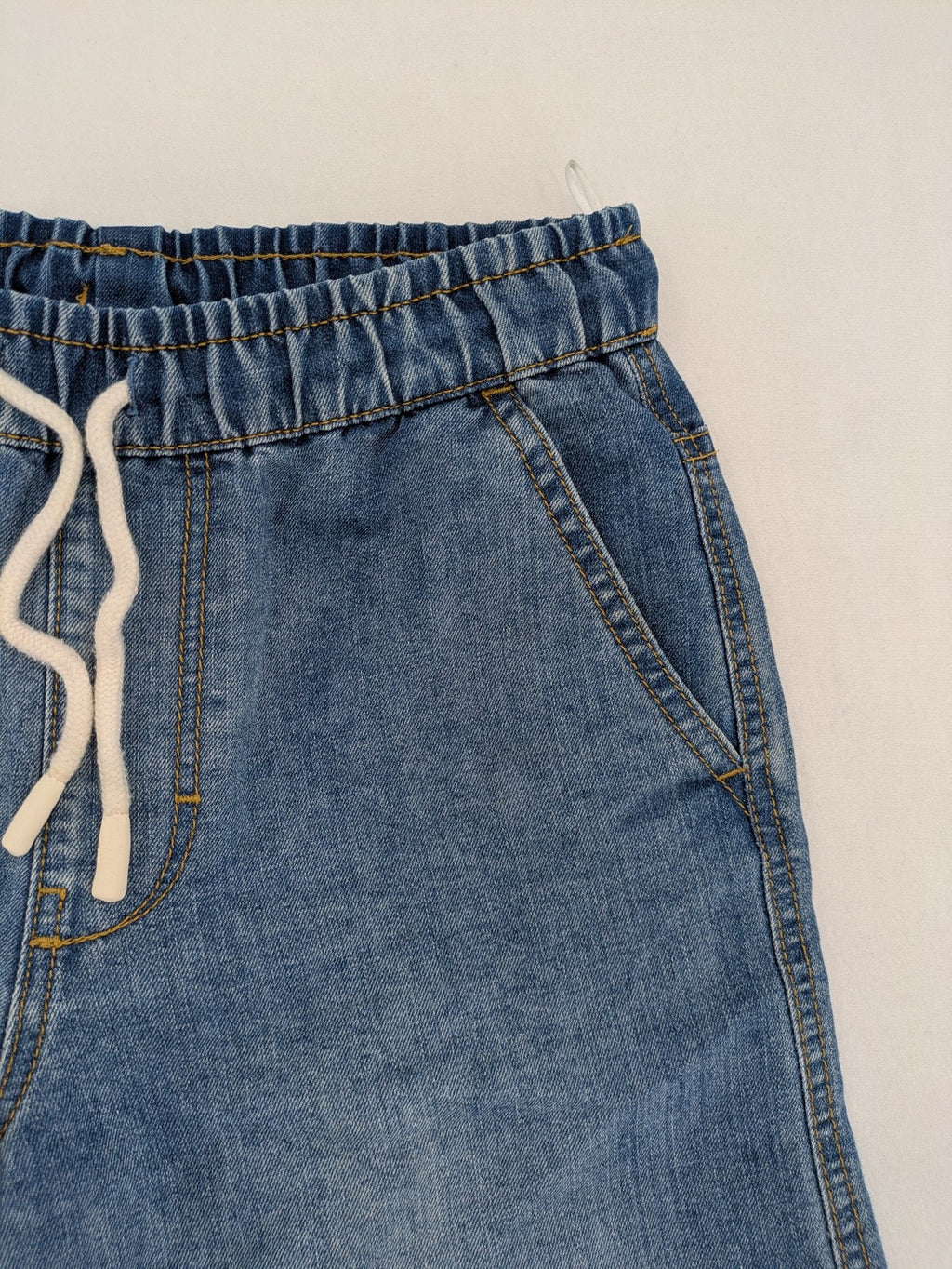 C&A blue denim shorts with elastic waistband and decorative drawstring, classic style.