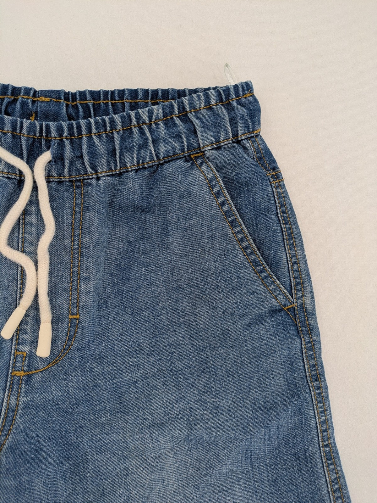 C&A blue denim shorts with elastic waistband and decorative drawstring, classic style.