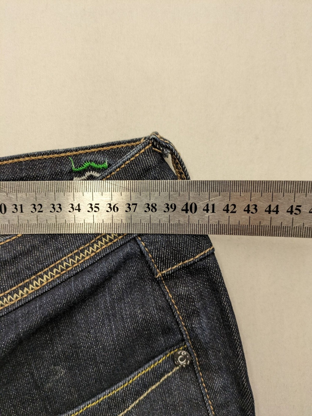 Furore blue straight jeans with yellow contrast stitching and zipper details.