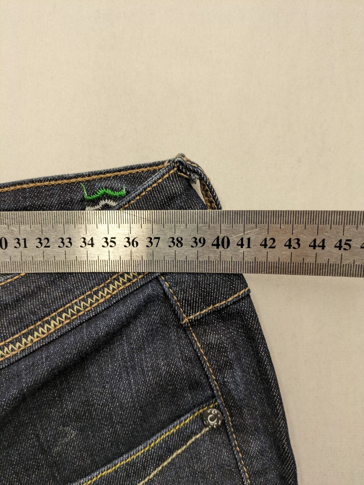 Furore blue straight jeans with yellow contrast stitching and zipper details.