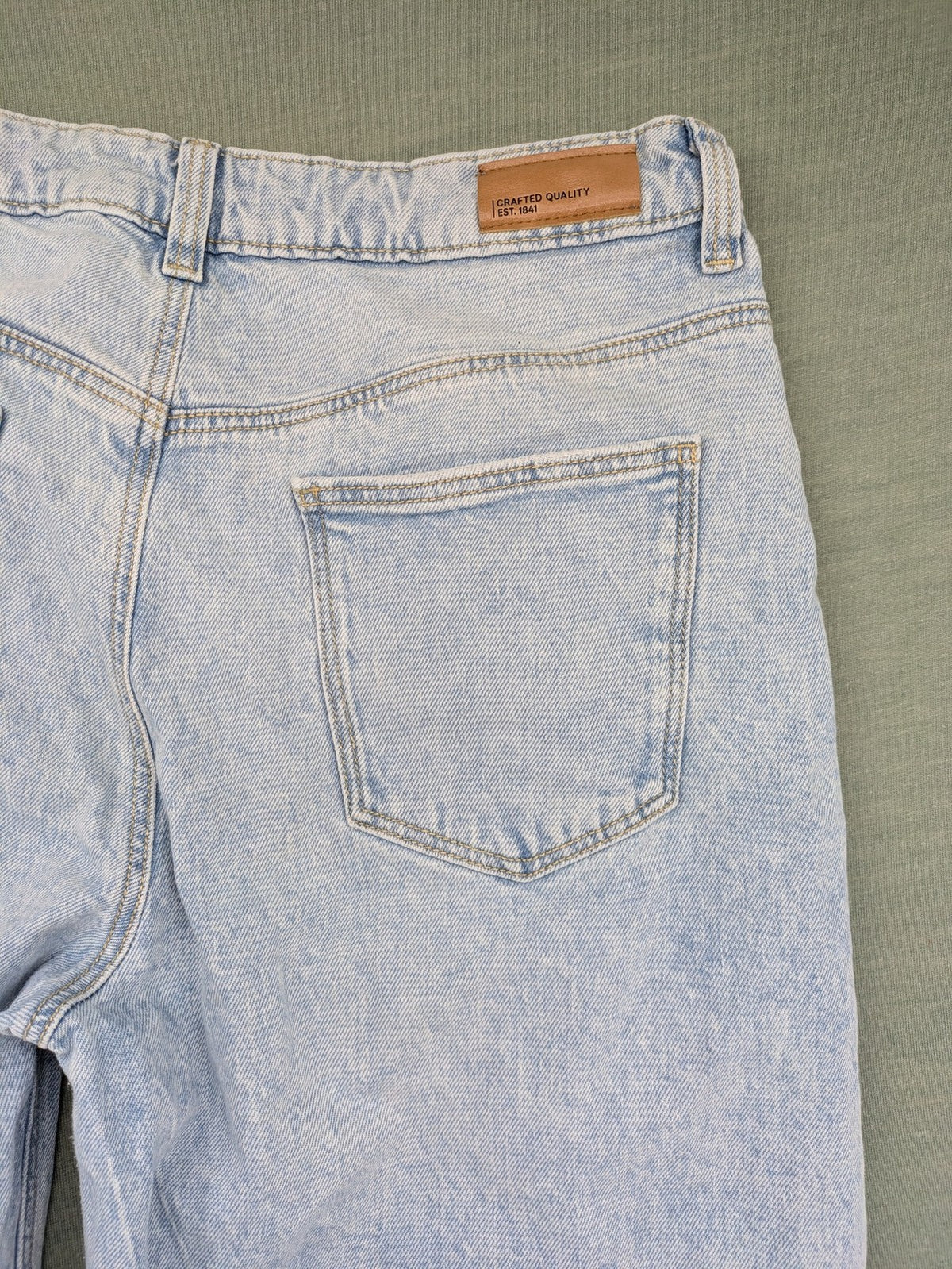C&A blue wide leg jeans with distressed knee details and classic five-pocket design.