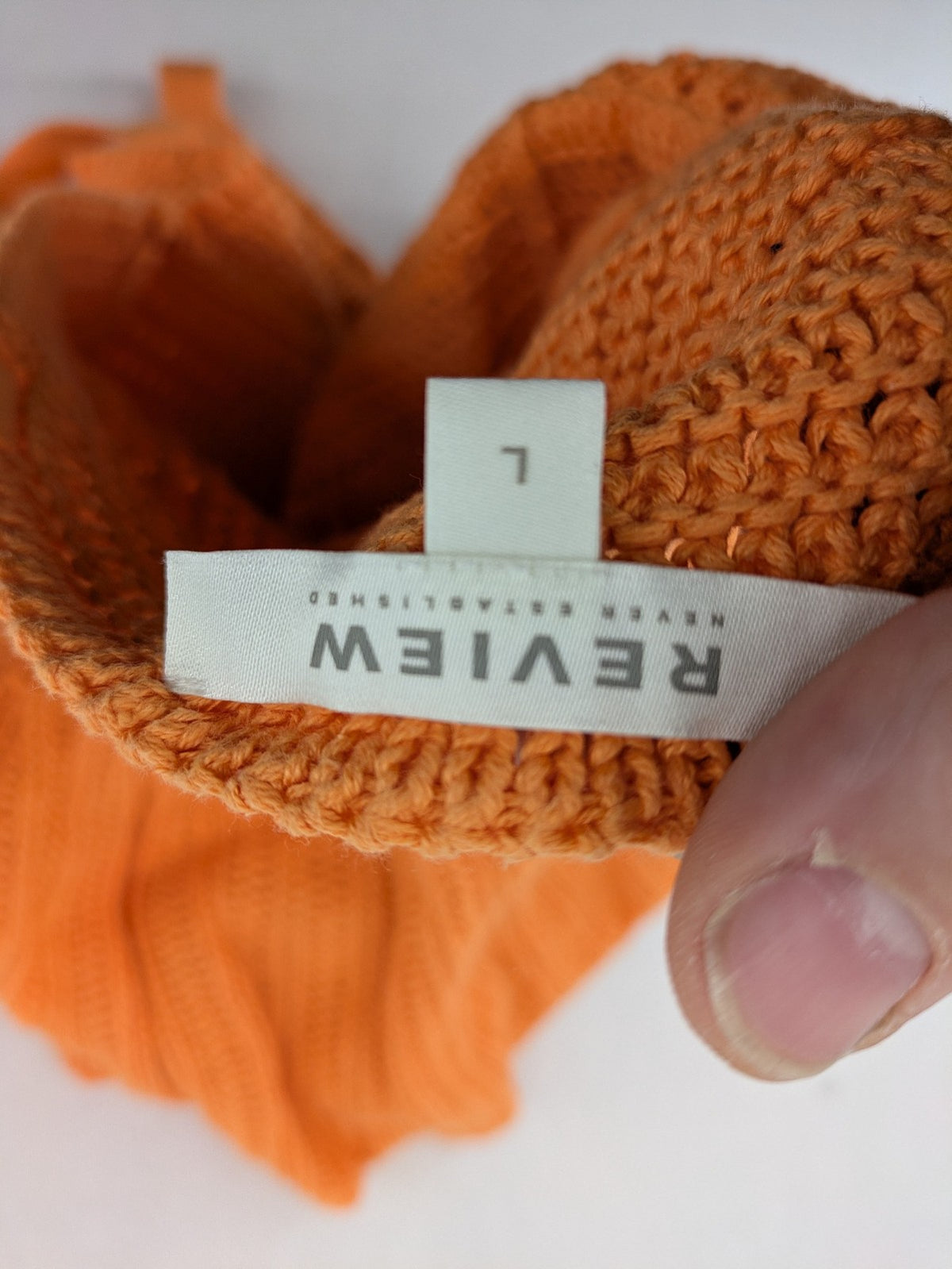REVIEW orange crochet top with V-neck and peplum hem, made from 100% cotton.