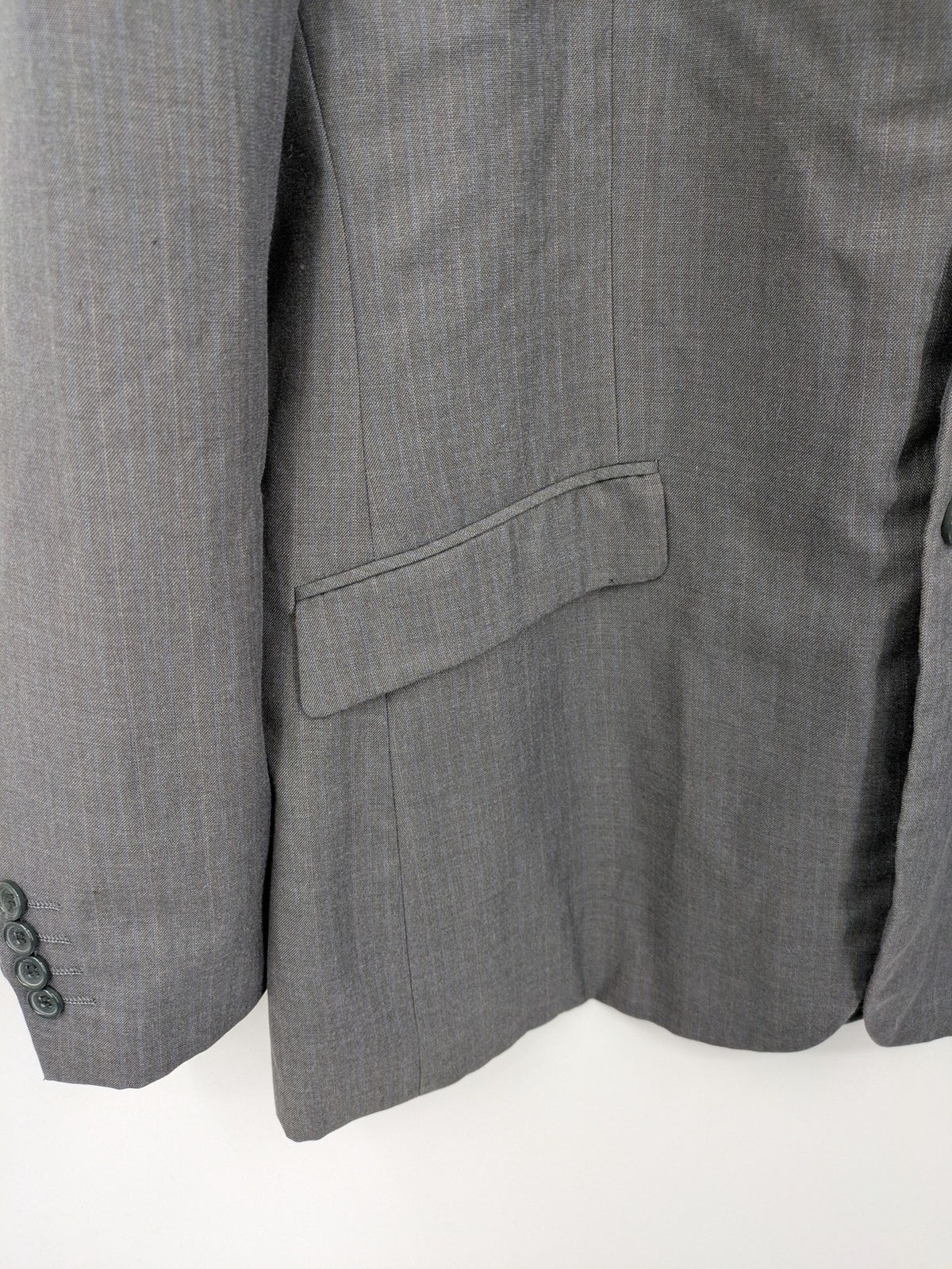 Alextrading grey jacket with subtle light blue pinstripe pattern and notch lapels.