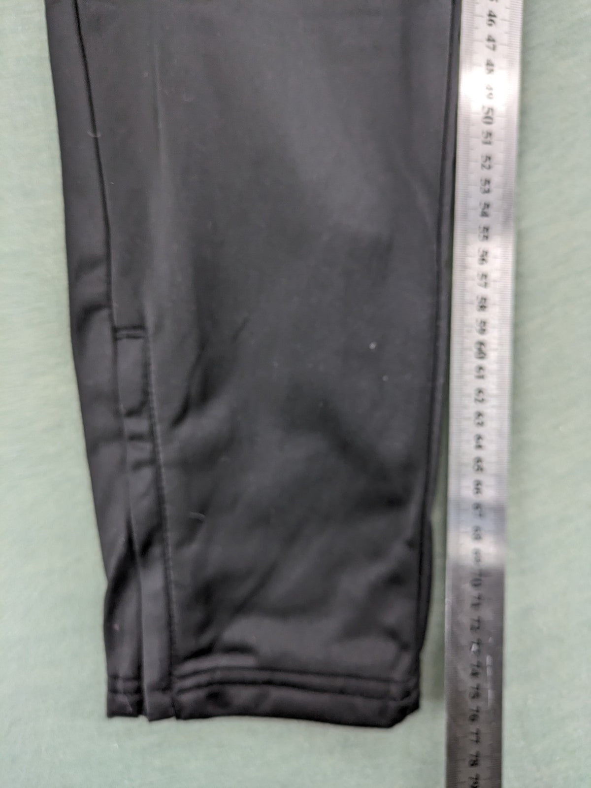 Crivit black weighted training pants with elastic waistband, side pockets, and zippered cuffs.